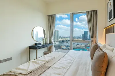 a bedroom with a large white bed and a large window at Lux 2 King Bed Suite - Grande Signature Residences in Dubai