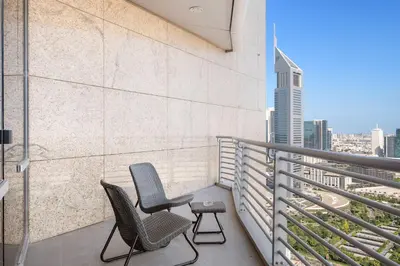 two chairs on a balcony with a view of the city at Silkhaus Gallery Studio at Sky Gardens in Heart of DIFC in Dubai