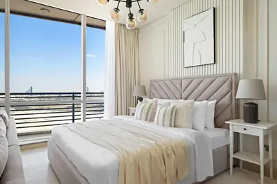 a bedroom with a large bed and a large window at Silkhaus Gallery Studio at Sky Gardens in Heart of DIFC in Dubai