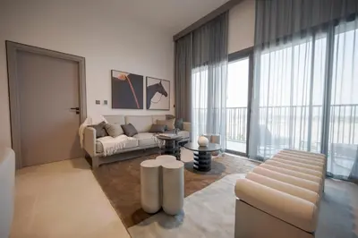 a living room with a couch and a table at Spacious Unit With Burj Khalifa View in Dubai