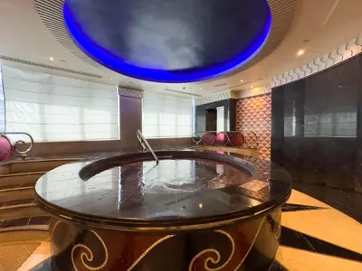 a bath tub in a room with a blue ceiling at 1BHK in Damac Masion mall street in Dubai