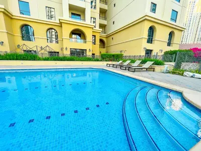 a large swimming pool in front of a building at HAPPY SEASON JBR apartments in Dubai