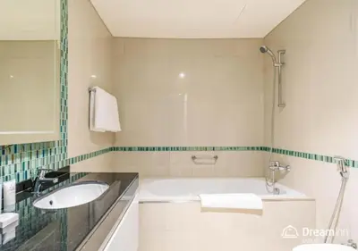 a bathroom with a tub and a sink at Dream Inn - Damac Heights Fendi in Dubai