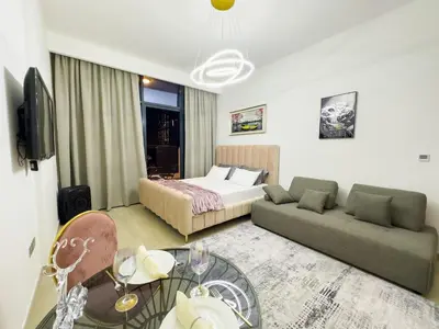 a hotel room with a bed and a couch at Studio in Azizi Riviera Dubai in Dubai