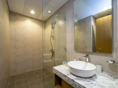a bathroom with a sink and a shower at 50th Floor 2 Bed with Burj and Sea view in Dubai