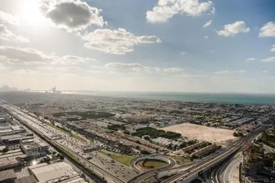an aerial view of a city with the ocean at 50th Floor 2 Bed with Burj and Sea view in Dubai