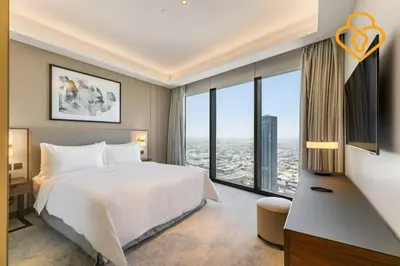 a bedroom with a large bed and a large window at Keysplease 2 BR Address Opera walking to Dubai Mall 55 in Dubai