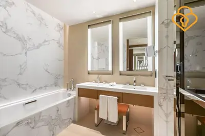a bathroom with a tub and two sinks and a bath tub at Keysplease 2 BR Address Opera walking to Dubai Mall 55 in Dubai