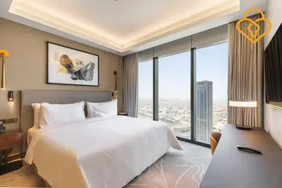 a bedroom with a white bed and a large window at Keysplease 2 BR Address Opera walking to Dubai Mall 55 in Dubai