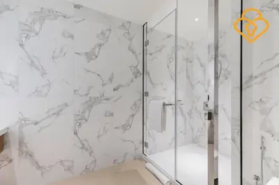 a shower with a glass door in a bathroom at Keysplease 2 BR Address Opera walking to Dubai Mall 55 in Dubai