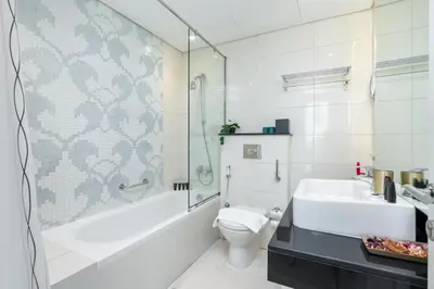 a bathroom with a tub and a toilet and a sink at Vacay Lettings - DAMAC Capital Bay Tower in Dubai