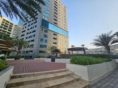 a large tall building with stairs in front of it at Vacay Lettings - DAMAC Capital Bay Tower in Dubai