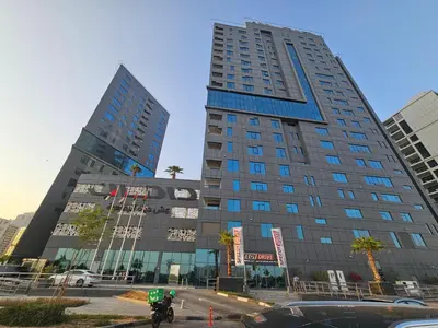 a tall building in a city with two tall buildings at Vacay Lettings - DAMAC Capital Bay Tower in Dubai