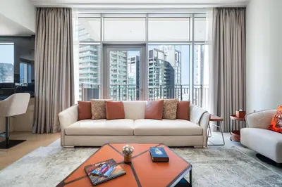 a living room with a couch and a large window at Downtown Luxury Treat - Premium Location! 2 bedroom! in Dubai