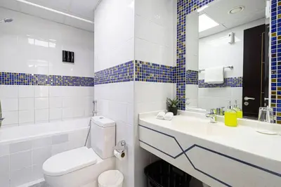 a bathroom with a toilet and a sink and a mirror at 2BR on 30th Floor in JLT Near Metro & Walking Distance to JBR Beach, Dubai Marina in Dubai