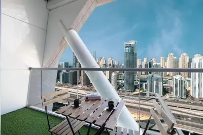 a balcony with a bench and a view of a city at 2BR on 30th Floor in JLT Near Metro & Walking Distance to JBR Beach, Dubai Marina in Dubai