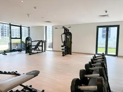 a gym with several treadmills and exercise bikes at Luxury 3BR near to Downtown - Burj Khalifa & Pool Views - 10 min to Dubai Mall in Dubai