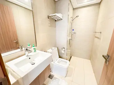 a white bathroom with a sink and a toilet at Luxury 3BR near to Downtown - Burj Khalifa & Pool Views - 10 min to Dubai Mall in Dubai