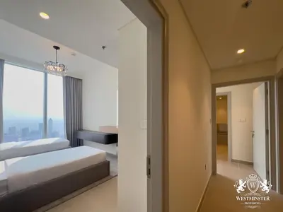 a bedroom with two beds and a sliding glass door at Westminster Forte Burj Khalifa in Dubai