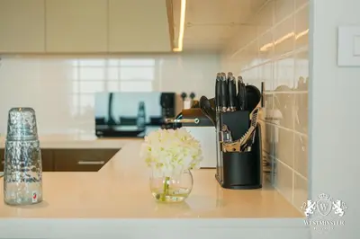 a kitchen counter with a vase of flowers and knives at Westminster Forte Burj Khalifa in Dubai