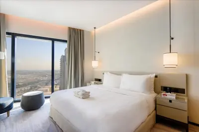 a bedroom with a large white bed and a large window at 1BHK with Marina Views and Beach Access in Dubai