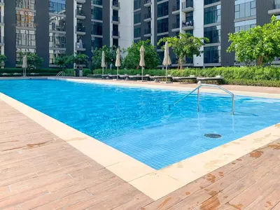 a large blue swimming pool in a building at Stylish Apartment with Golf Views in Dubai Hills 199GV-2 in Dubai