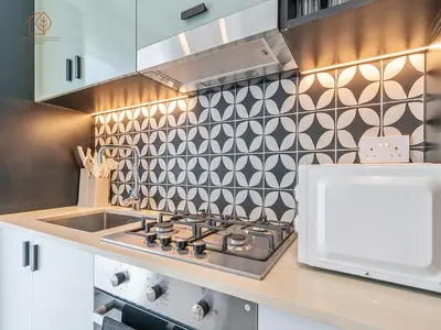 a kitchen with a stove and a sink at Stylish Apartment with Golf Views in Dubai Hills 199GV-2 in Dubai