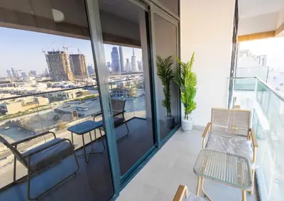 a balcony with chairs and a view of the city at Burj Khalifa View Pool Gym 10 Min To Downtown in Dubai
