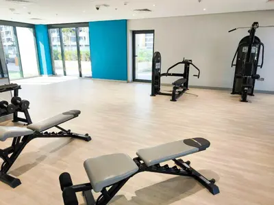 a gym with several treadmills and exercise bikes at Burj Khalifa View Pool Gym 10 Min To Downtown in Dubai