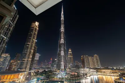 a view of a city skyline at night at GuestReady - Charming stay with Burj Khalifa views in Dubai