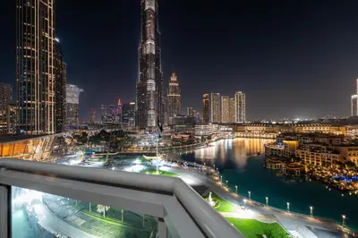 a view of a city skyline at night at GuestReady - Charming stay with Burj Khalifa views in Dubai