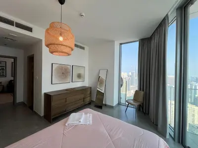 a bedroom with a pink bed and a large window at Dubai Marina stunning views holiday apartment Stella Maris Tower in Dubai