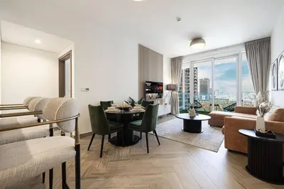 a living room with a dining table and a couch at Chic 2 Bed Near Trade Centre with 5 Star Amenities in Dubai