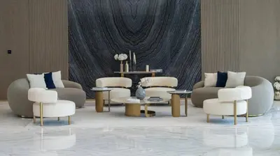 a living room with couches and chairs and a table at Modern 1br In Jvc Pool, Balcony & Free Parking in Dubai