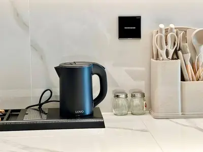 a blue coffee pot sitting on top of a counter at Modern 1br In Jvc Pool, Balcony & Free Parking in Dubai