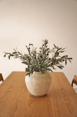 a plant in a vase sitting on a table at Luxury Seaview 2BR - Paramount Midtown - 6 Guests - 64F Pool Access & Burj View in Dubai