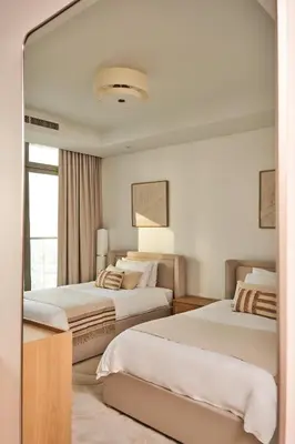 a hotel room with two beds and a window at Luxury Seaview 2BR - Paramount Midtown - 6 Guests - 64F Pool Access & Burj View in Dubai