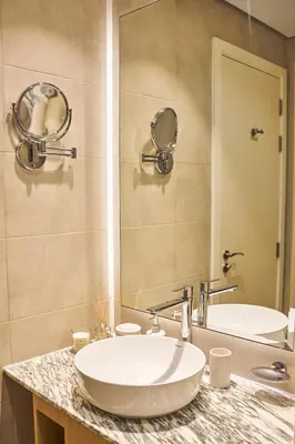 a bathroom with a sink and a mirror at Luxury Seaview 2BR - Paramount Midtown - 6 Guests - 64F Pool Access & Burj View in Dubai