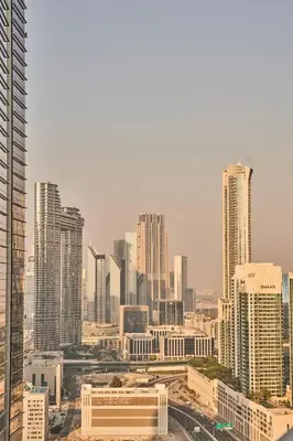 a view of a city with tall buildings at Luxury Seaview 2BR - Paramount Midtown - 6 Guests - 64F Pool Access & Burj View in Dubai