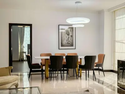 a dining room with a table and chairs at Spacious 4BR Duplex with Terrace - JBR in Dubai