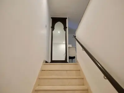 a stairway with a mirror and a mirrorigunigunigunigunigunigunigun at Spacious 4BR Duplex with Terrace - JBR in Dubai