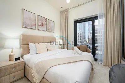 a bedroom with a large bed and a large window at Chic Studio in Azizi Riviera 46, Al Merkadh by Deluxe Holiday Homes in Dubai