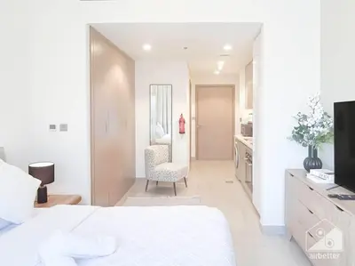 a white bedroom with a white bed and a desk at Elegant Stay in Meydan Balcony & Stunning Views in Dubai