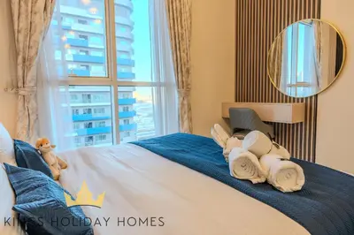 a bedroom with a bed with towels and a window at Luxury Apartments Dunya tower Burj Khalifa St kings in Dubai