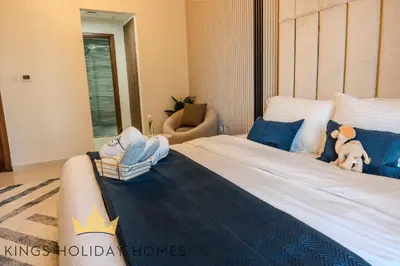 a bedroom with a large bed with a teddy bear on it at Luxury Apartments Dunya tower Burj Khalifa St kings in Dubai