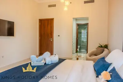 a bedroom with a king sized bed and a chair at Luxury Apartments Dunya tower Burj Khalifa St kings in Dubai