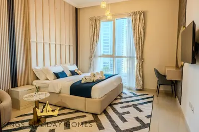 a bedroom with a bed and a large window at Luxury Apartments Dunya tower Burj Khalifa St kings in Dubai