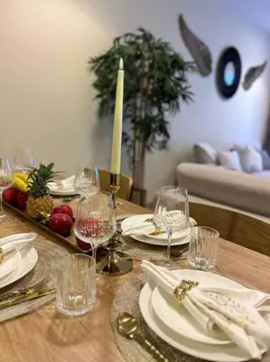 a table with plates and wine glasses on it at 1BHK in Dubai Marina near tram in Dubai
