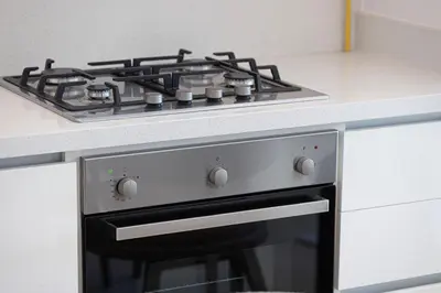 a stove top oven in a white kitchen at Dubai Mall Connected! AMAZING Burj Khalifa View! Excellent Pool & Gym Access! in Dubai
