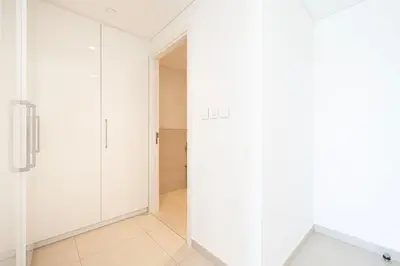 a bathroom with white cabinets and a glass door at Dubai Mall Connected! AMAZING Burj Khalifa View! Excellent Pool & Gym Access! in Dubai